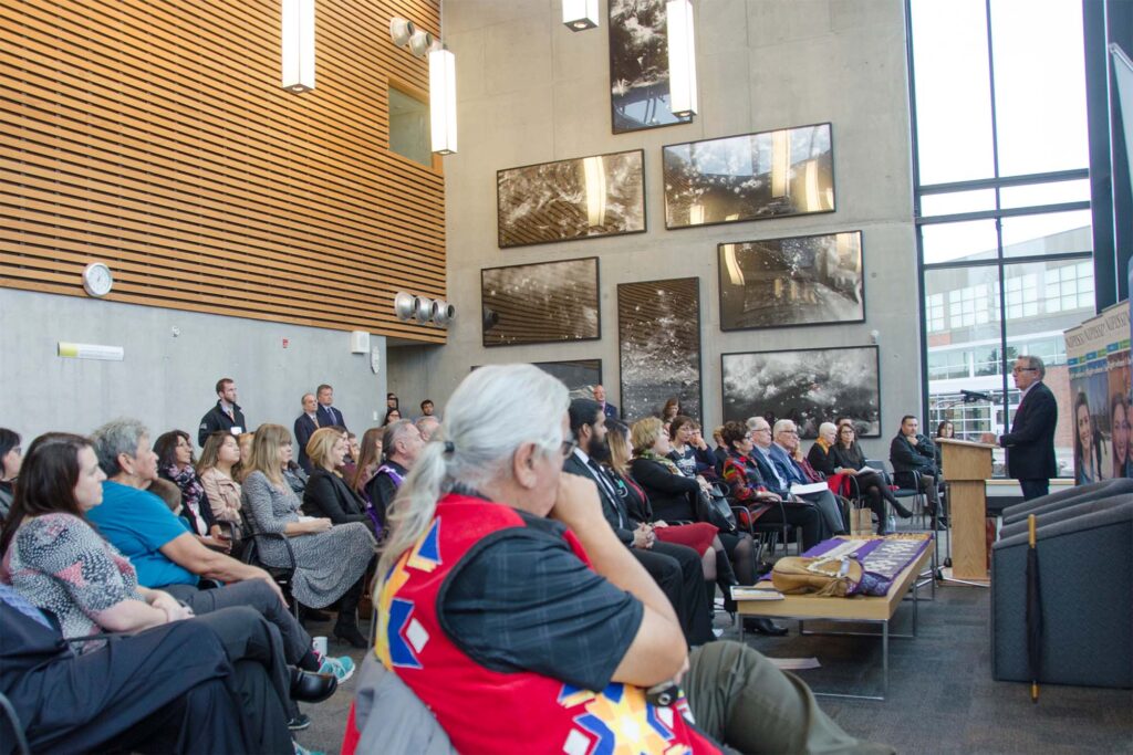 An Indigenous gathering full of people in the library