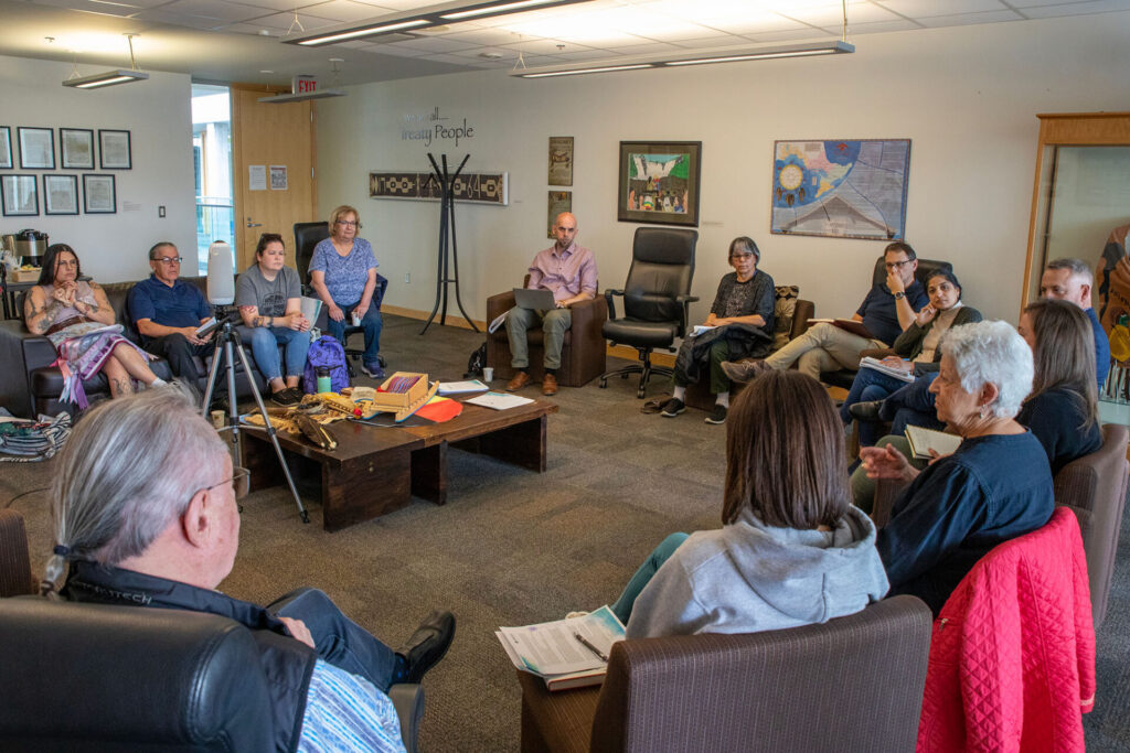 A group of people having a discussion in an indoor open space